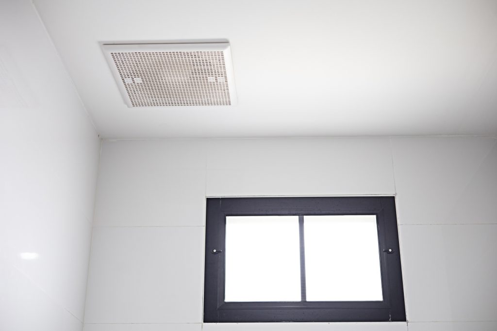 Ceiling-mounted exhaust fan in a modern bathroom, highlighting professional bathroom exhaust fan installation Melbourne by Approved Electrix.