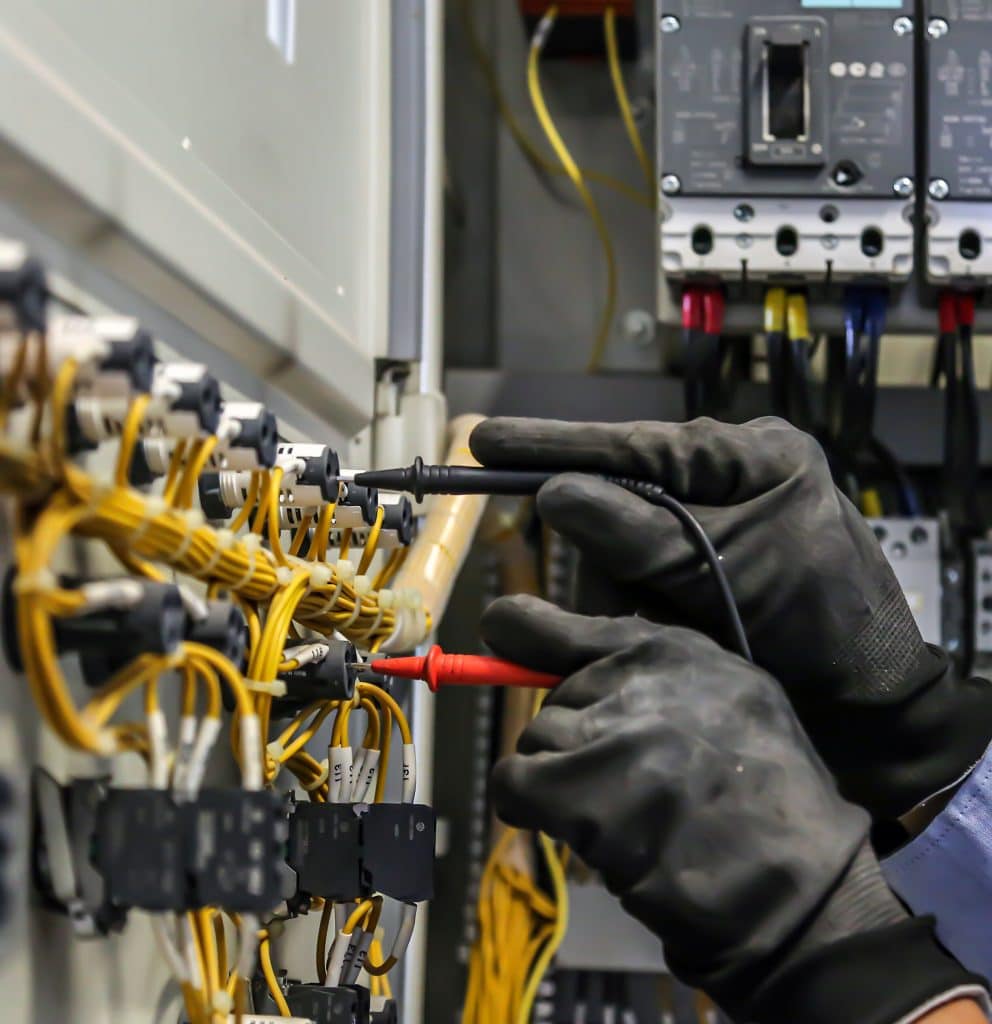 Close-up of an electrician conducting a rental electrical safety check, ensuring compliance with gas and electrical safety checks for rental property in Victoria. Essential services for electrical safety check rental properties and rental safety checks in Melbourne.